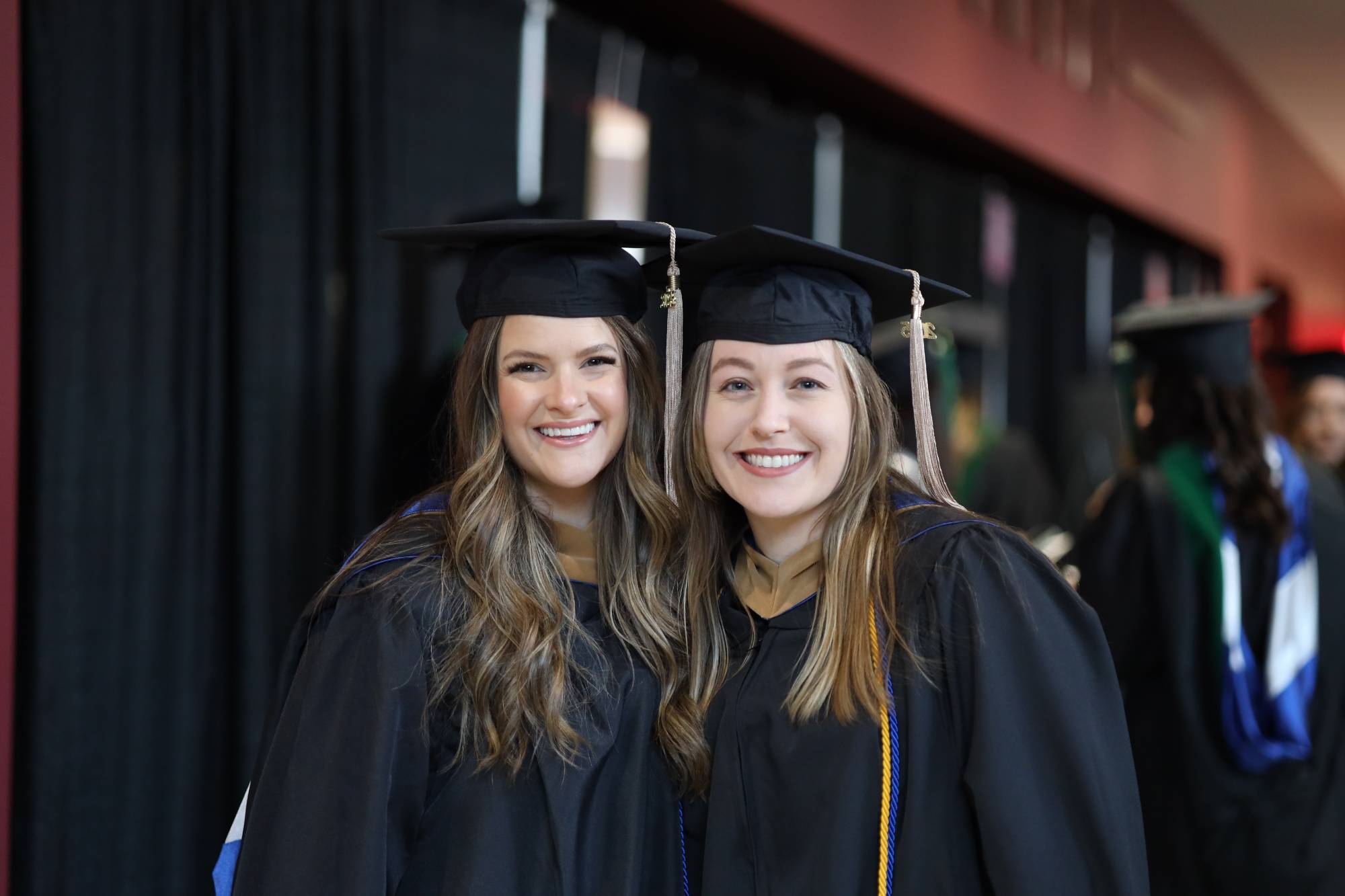 two GVSU grads smiling